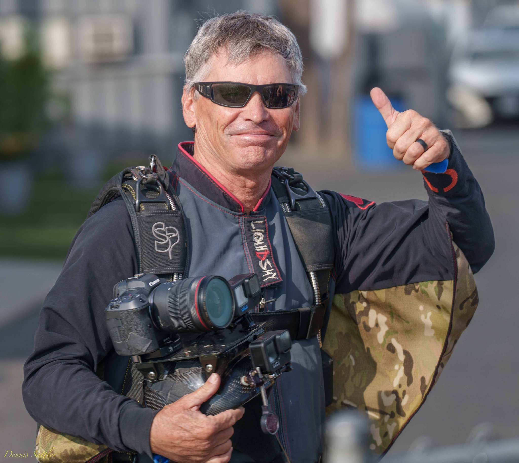 skydiving videographer and photographer, Craig O'Brien gives a thumbs up before boarding a skydiving plane.