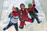 solo skydiving student exits aircraft with PSP AFF instructors at Skydive Perris learning to skydive solo near San Diego