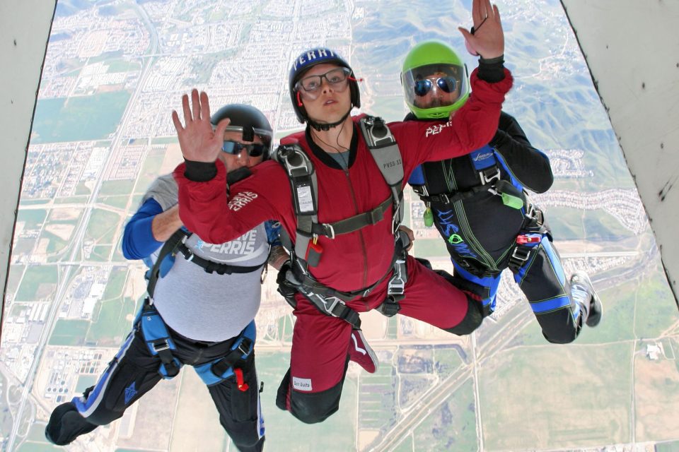 solo skydiving student exits aircraft with PSP AFF instructors at Skydive Perris learning to skydive solo near San Diego