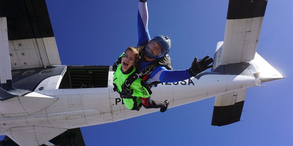 a tandem student exits a twin otter at 12,500' at Skydive Perris